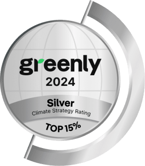 A silver badge with greenly 2024 at the center, Silver Climate Strategy Rating below, and TOP 15% at the bottom, signifying recognition for top 15% climate strategy performance.